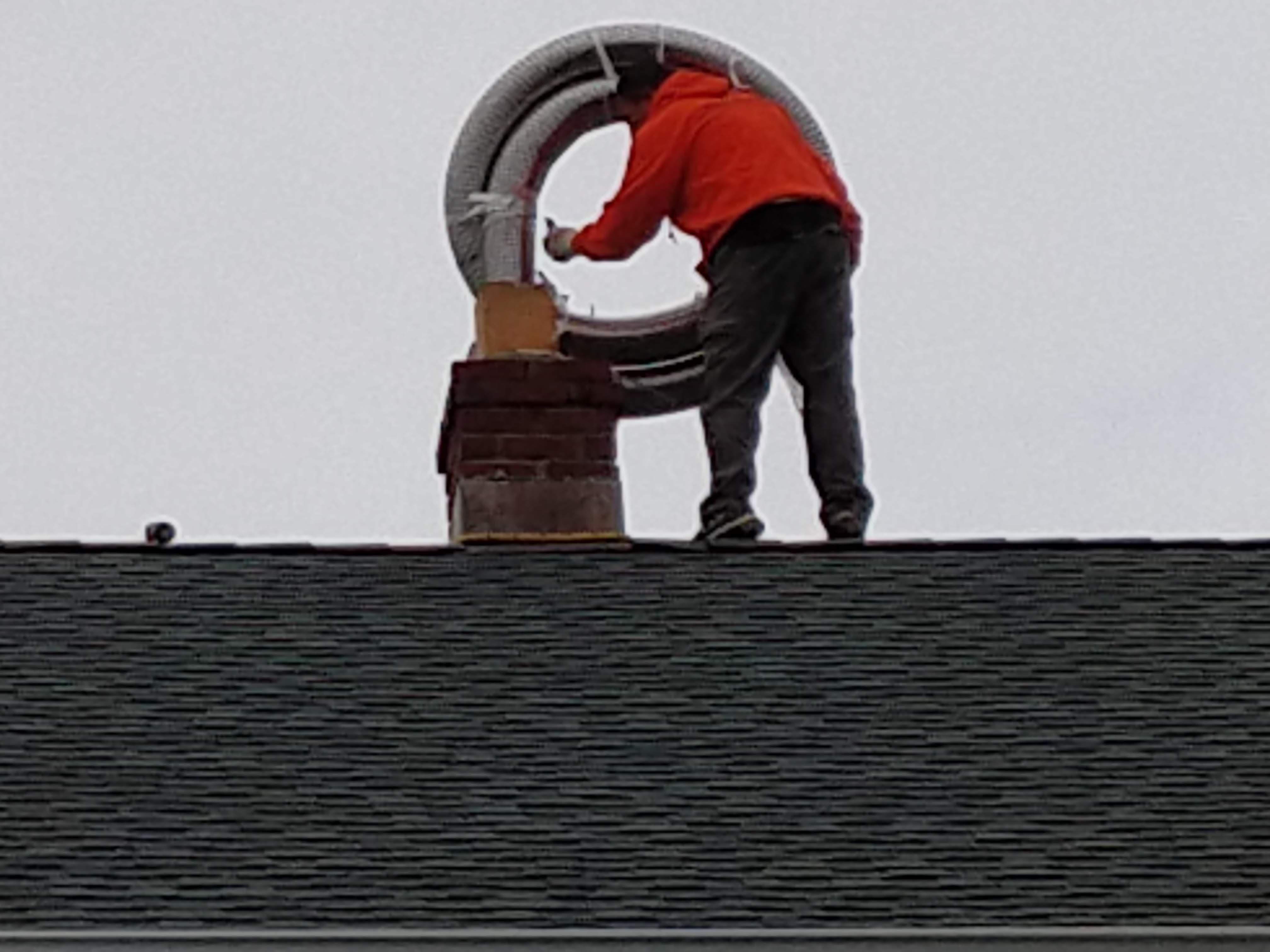 Flexible stainless chimney liner being installed in Farmingdale, New York