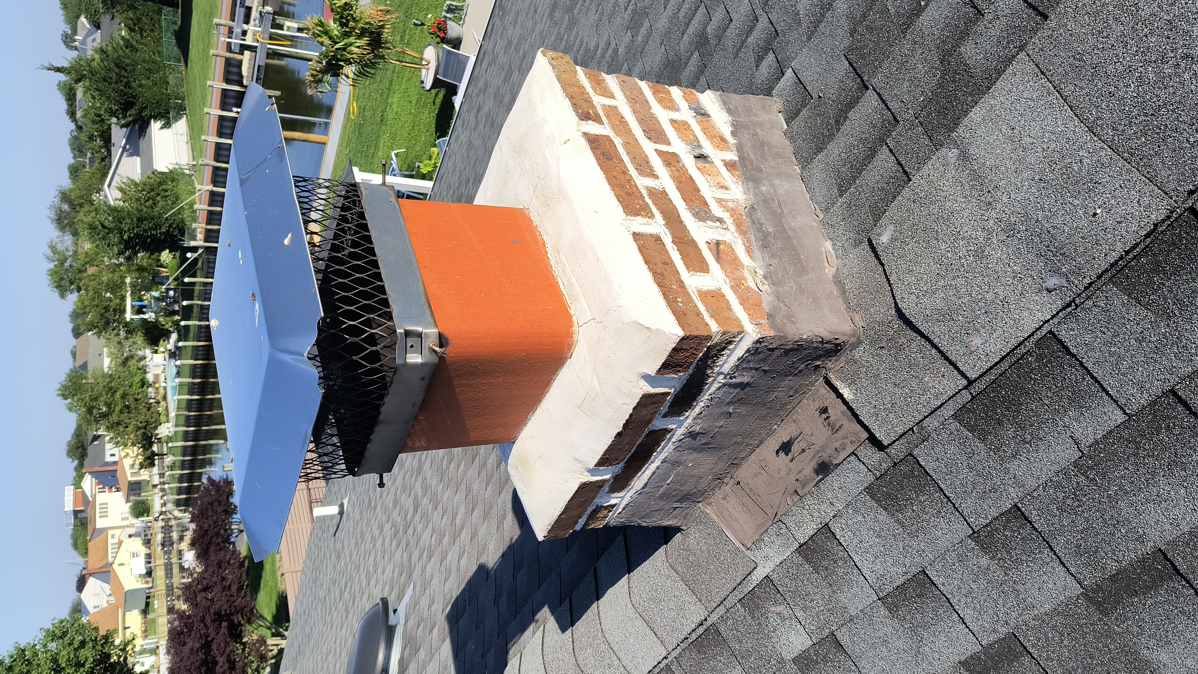 A DAMAGED CHIMNEY CROWN BEFORE REPAIR IN FARMINGDALE