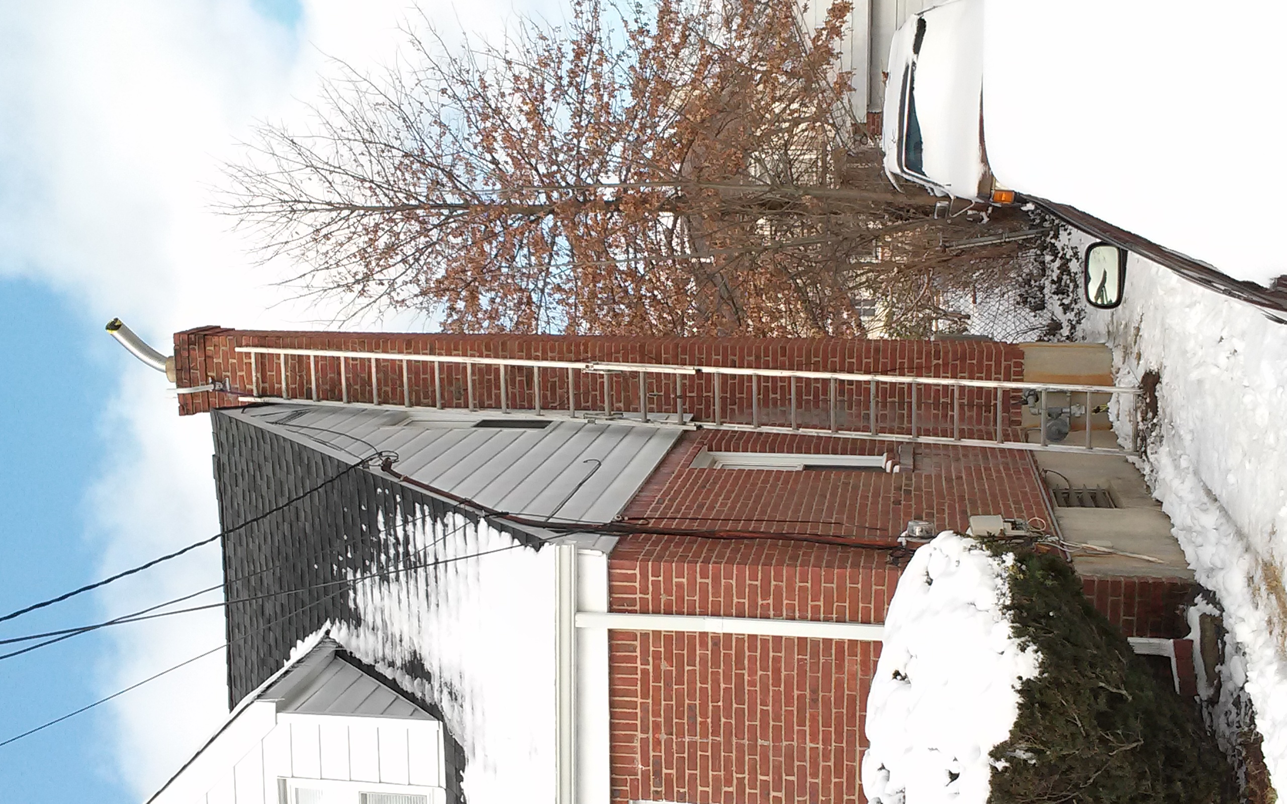 A FINISHED STAINLESS STEEL CHIMNEY LINER INSTALLATION, READY TO PROTECT THE HOME IN FARMINGDALE