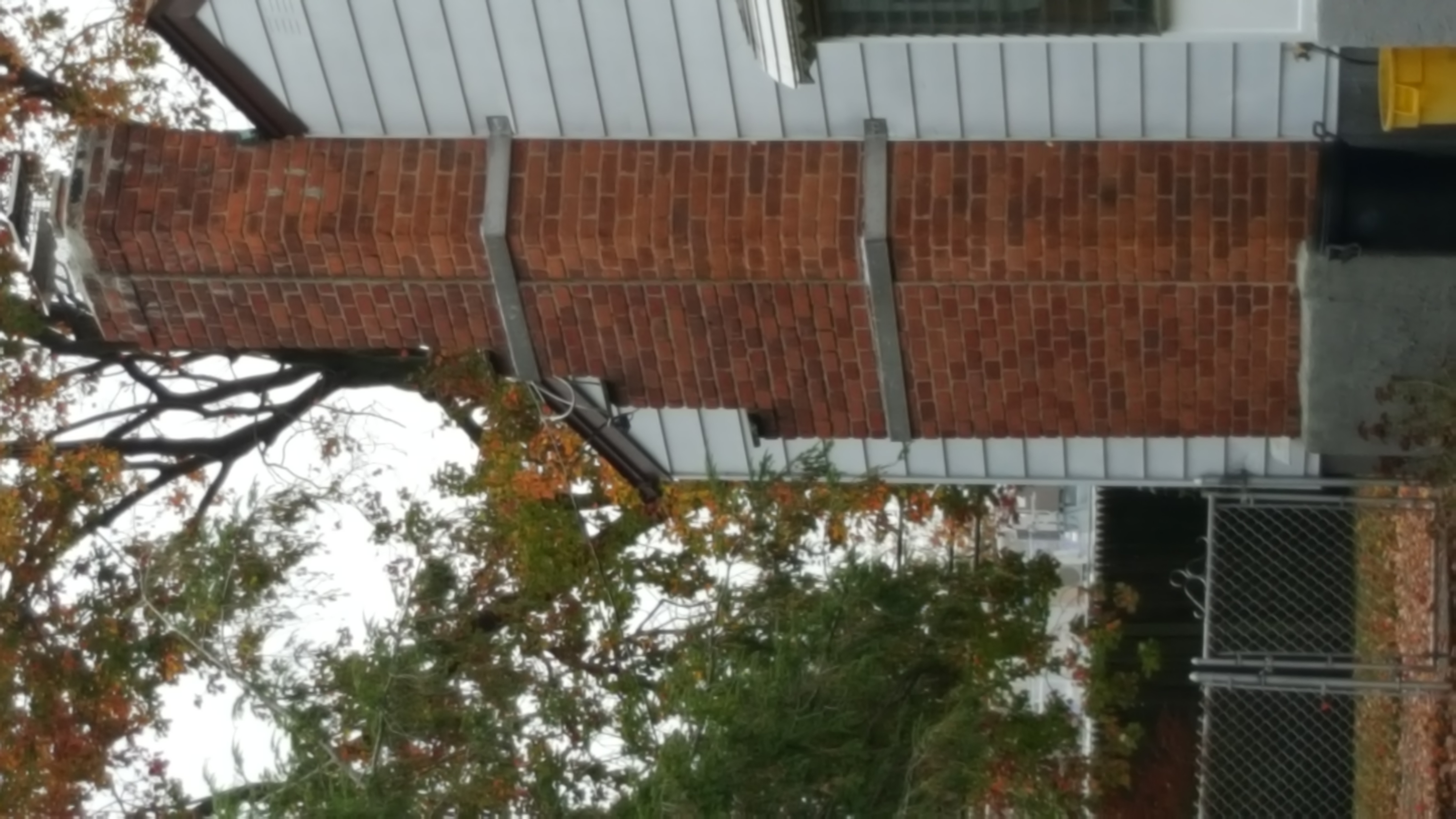 AN OLD CHIMNEY WITH CRACKED AND MISSING MORTAR, BEFORE REPAIR IN FARMINGDALE
